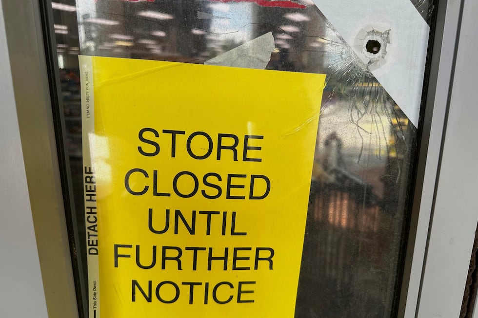 Vista de la puerta de una farmacia CVS perforada por una bala el sábado 9 de agosto de 2025,...