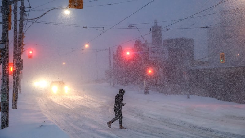 Gente camina por el centro de Toronto mientras una tormenta invernal pasa por la región, el...