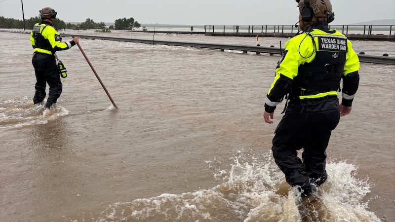 In this handout photo provided by the Texas Parks and Wildlife Department, game wardens walk...