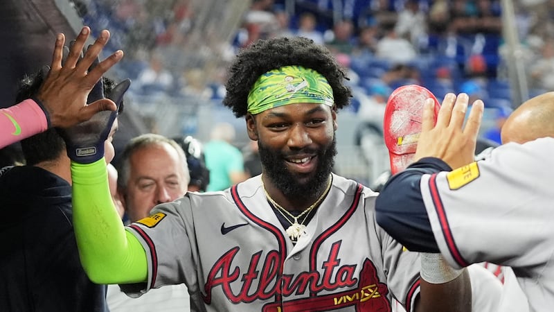 Michael Harris II de los Bravos de Atlanta es felicitado tras anotar un elevado de sacrificio...