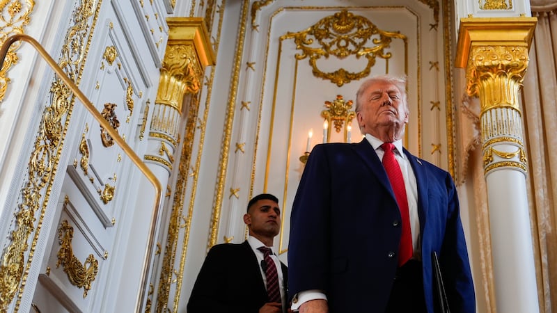 A Secret Service agent stands watch as President Donald Trump arrives at a dedication ceremony...